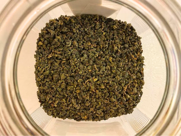 Tung Ting Oolong Tea leaves in a jar