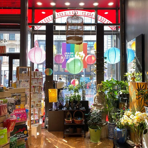 Storefront of Pearl River Mart at 452 Broadway from inside. Light shining through