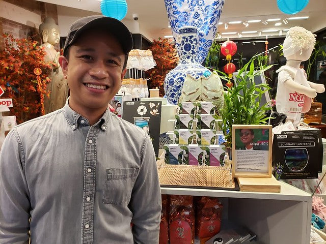 Miguel Carrasco in front of his display of soaps at Pearl River Mart in Chelsea Market