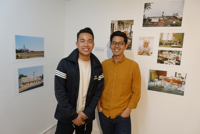 Photographers Andrew Kung and Emanuel Hahn in front of their photos in the Pearl River Mart gallery