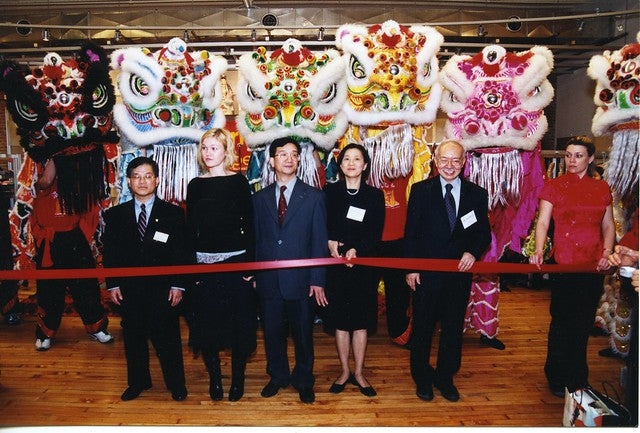 Julia Styles, Mr. and Mrs. Chen in front of lion dancers at grand opening of 477 Broadway location of Pearl River Mart 