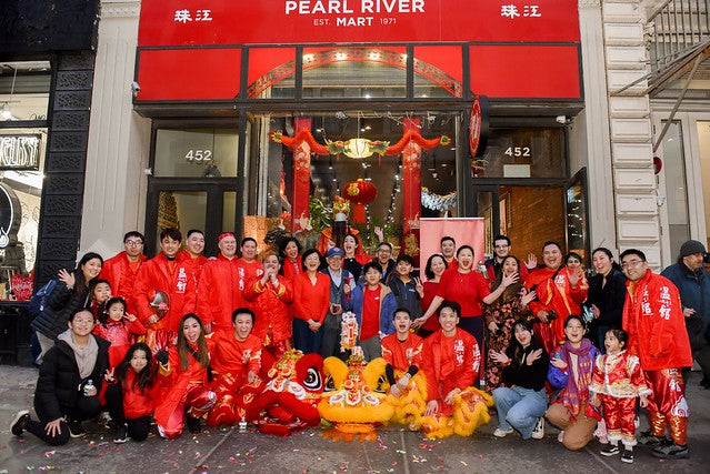 Wan Chi Ming lion dance troupe with Pearl River Mart employees in front of Pearl River Mart's Soho location