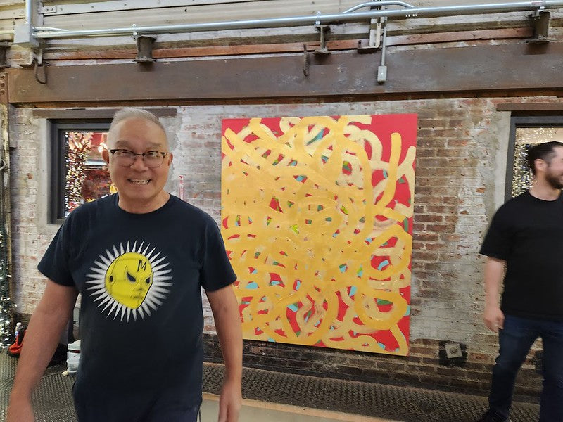 Arlan Huang with his painting in Chelsea Market