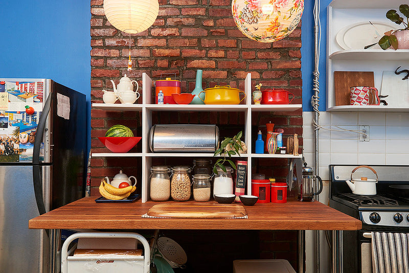 Table in kitchen with shelving and lanterns