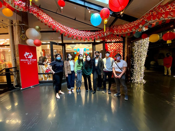 Futures Ever Arriving artists and curator in front of Pearl River Mart in Chelsea Market