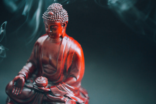 Buddha statue with smoke from incense