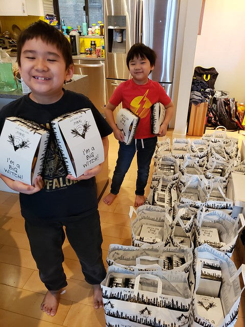 Two boys surrounded by lots of Fat Witch brownie bags
