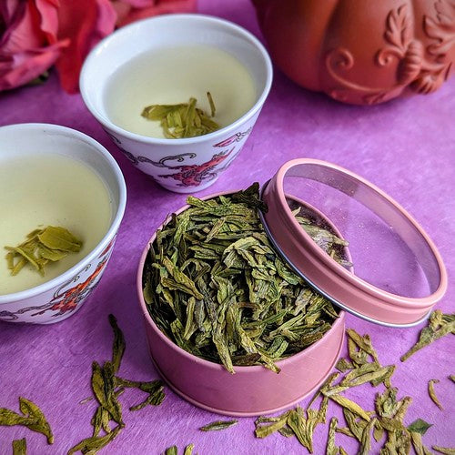 Ming Qian Longqing tea in pink canister with tea cups