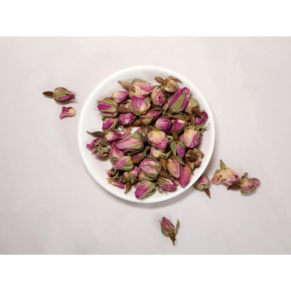 Dried pink rose buds in dish