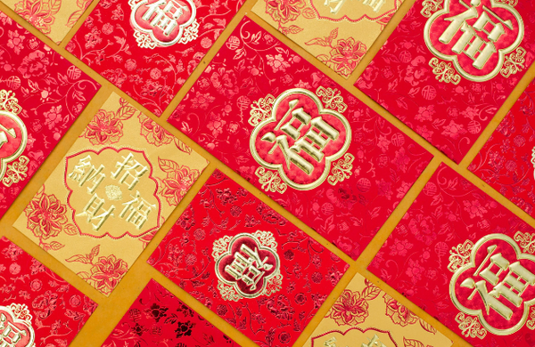 Flatlay of red and gold lucky envelopes