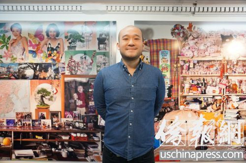 Photographer Louis Chan in front of one of his large-scale photos