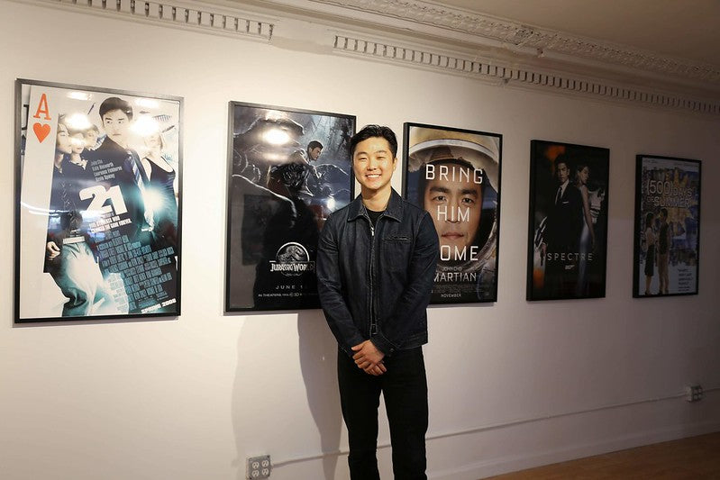 Artist-in-residence William Yu with posters from his exhibition