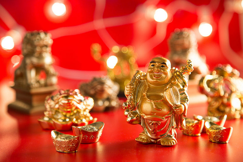Beautiful gold figurines of Buddha, ingots, money toads, and fu dogs