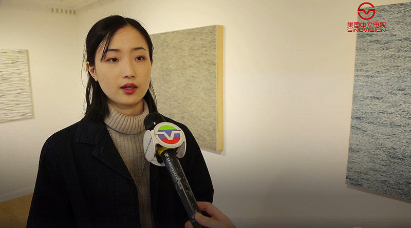 Artist Yingqian Ciao talking to a Sinovision reporter in the Pearl River Mart gallery