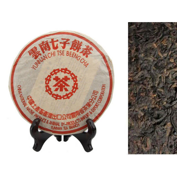 Yunnan Chi Tse Pu Erh Compressed tea on a stand. Next to Yunnan loose tea