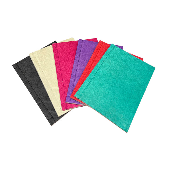 Set of colorful silk cover notebooks on a white background