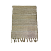 Woven table runner with striped pattern and fringes on a white background