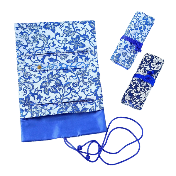 Blue and white floral-patterned bag with matching pouches on a white background