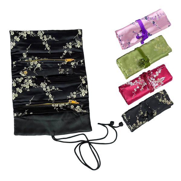 Black satin bag with floral embroidery and a set of matching hair accessories on a white background
