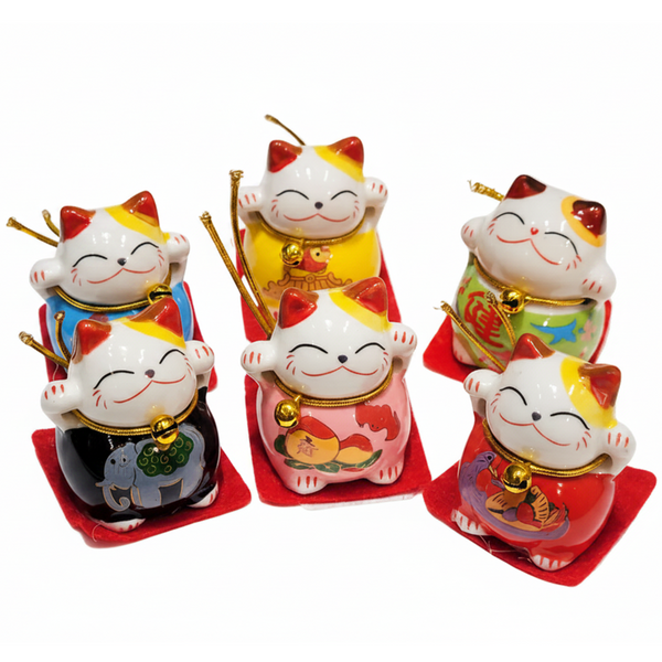 Set of six colorful cat figurines with traditional designs on a white background