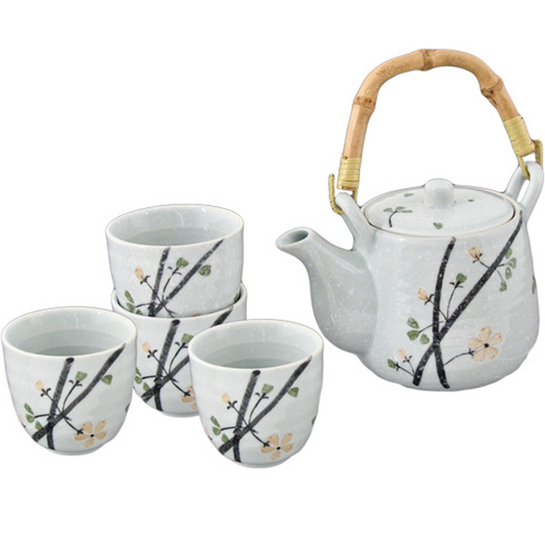 Tea set with teapot and cups featuring branch and flower design on a white background