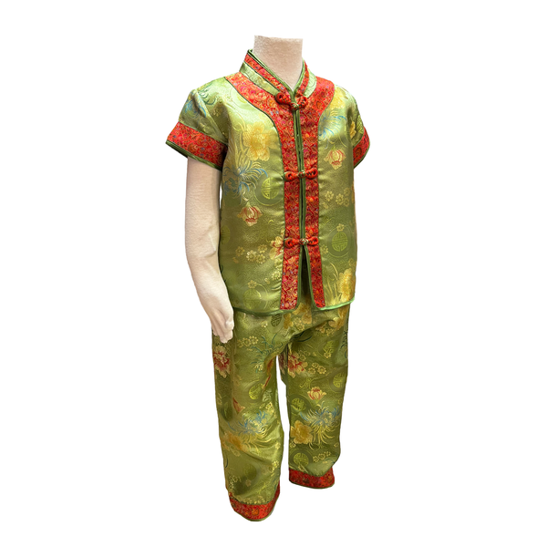 Traditional kids outfit in green with red trim and floral pattern on mannequin