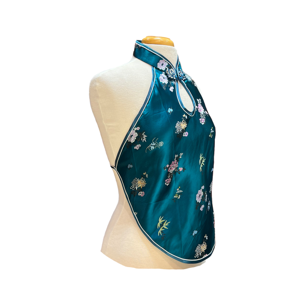 Teal halter top with white flowers on mannequin on white background