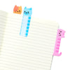 Sample pink sticky note and blue and orange sticky tab on a notebook.
