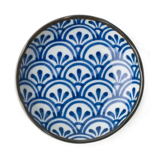 Ceramic plate with blue and white geometric pattern on a white background