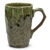 Green ceramic mug with a textured surface on a white background