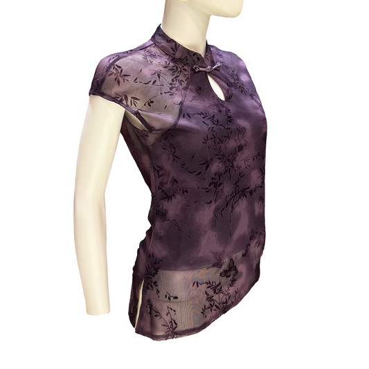 Purple floral blouse on a mannequin against a white background