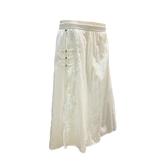 White skirt with green buttons on a white background