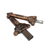 Decorative bronze key-shaped object on a white background