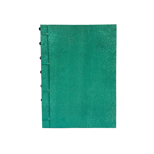 Green textured notebook with black rings on a white background
