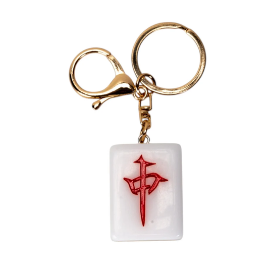 A keychain featuring a white rectangular pendant with a red Japanese-style symbol, attached to a gold-tone lobster clasp and split key ring on a plain white background.