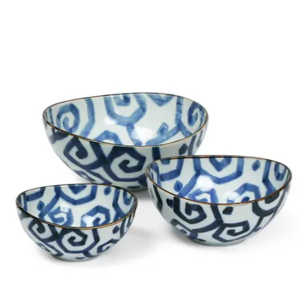 Three ceramic bowls with blue geometric pattern on a white background