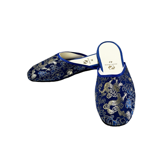 Pair of blue embroidered slippers on a white background
