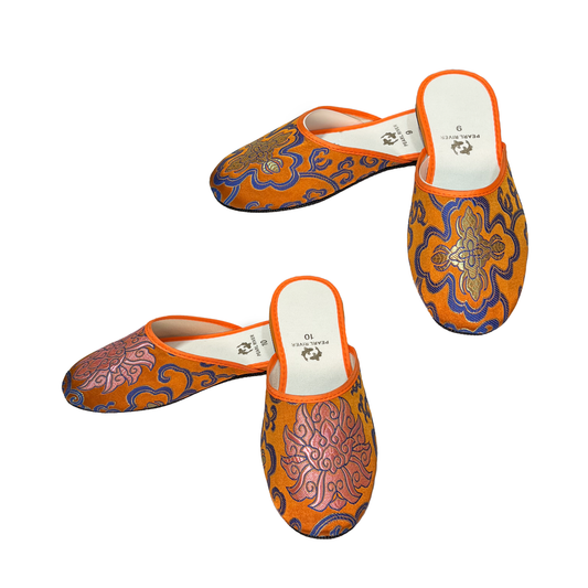 Two pairs of orange slippers with blue lotus design