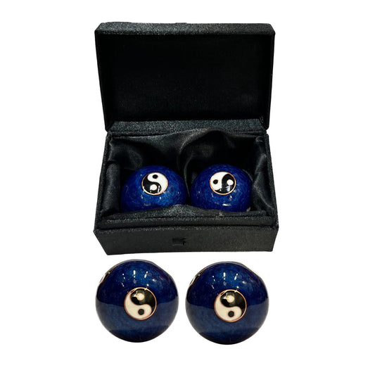 Set of blue balls with yin yang symbol in a black box on a white background