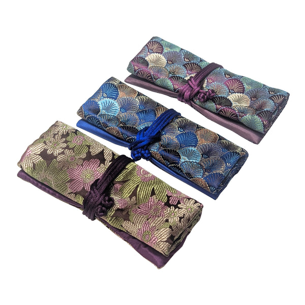 Three brocade jewelry rolls, tied up