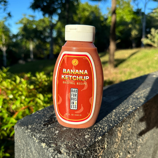 Bottle of banana ketchup on a stone ledge with a natural background