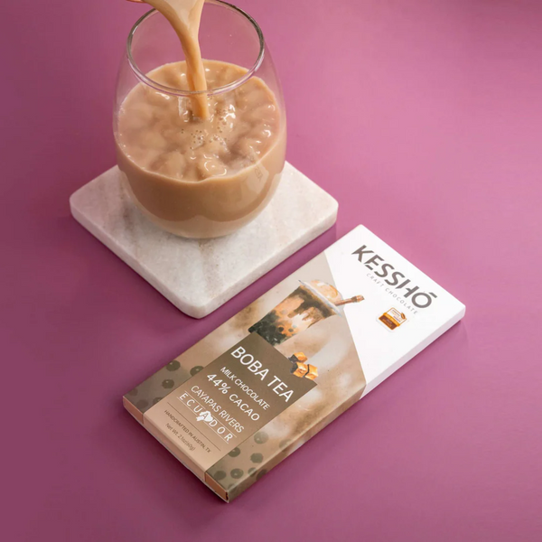Kessho Boba Tea package with a glass of tea being poured on a pink background