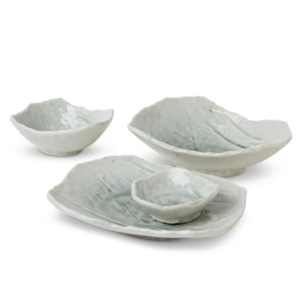 Set of ceramic bowls and platter on a white background