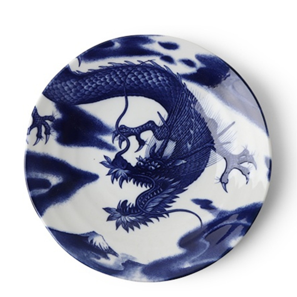 Blue and white ceramic plate with dragon design on a white background