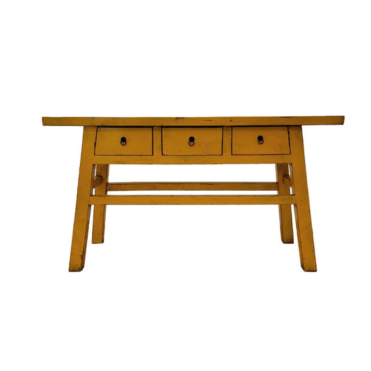 Wooden table with three drawers on a white background