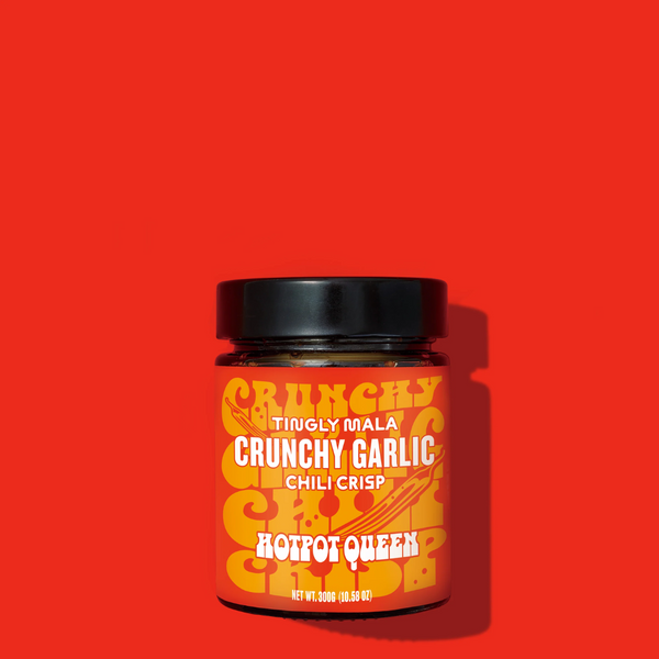 Jar of Crunchy Garlic Chili Crisp on a red background