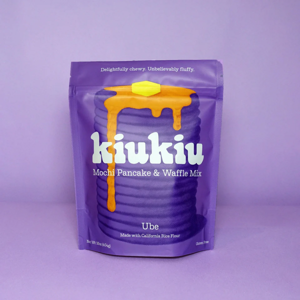 Purple package of kiukiu Ube mochi pancake and waffle mix on a purple background