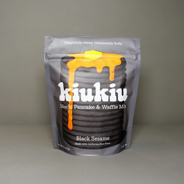 Packaging of kiukiu Mochi Pancake & Waffle Mix in black sesame flavor on a gray background