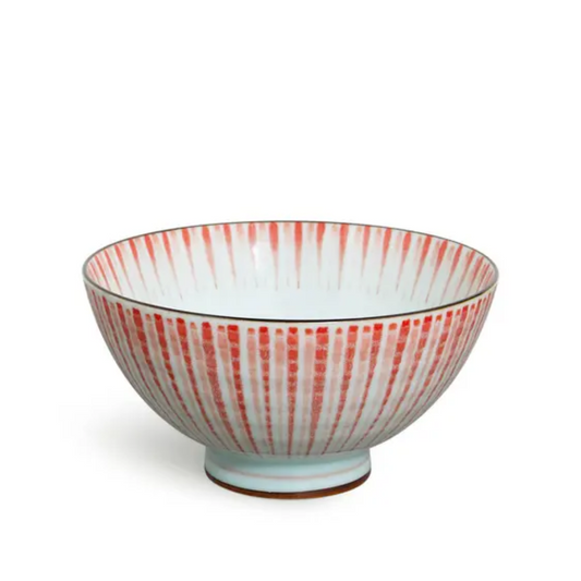 Ceramic bowl with red and white striped pattern on a white background