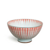 Ceramic bowl with pink and white striped pattern on a white background